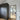Modern interior with black framed glass hinged door and dark textured wardrobe on wooden floor