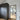 Modern interior with black framed glass hinged door and dark textured wardrobe on wooden floor