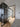 Modern interior with black framed glass hinged door and sliding doors over light wood floor