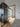 Modern interior with black framed glass hinged door and sliding doors over light wood floor