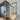 Modern glass hinged door with black metal frame in a bright room with wooden floor