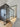 Modern glass hinged door with black metal frame in a bright room with wooden floor