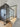Modern glass hinged door with black metal frame in a bright room with wooden floor