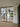 Black framed double hinged glass doors separating modern interior with wooden stairs and outdoor green view