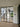 Black framed double hinged glass doors separating modern interior with wooden stairs and outdoor green view