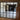 Modern double black metal frame glass doors with two side panels separating living room and kitchen