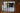 Modern double black metal frame glass doors with two side panels separating living room and kitchen