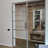 Modern double hinged glass door with metal frame in a minimalist interior space