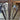 Close-up of sleek stainless steel double hinged glass door handles in modern living room