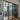 Modern living room separated by black steel frame double glass doors and side panels with wooden floor