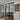 Modern black-framed double glass doors with two side panels in a bright home entryway