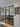 Modern black-framed double glass doors with two side panels in a bright home entryway