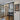 Modern interior with black-framed double glass doors, wooden floor, entry door, and decorative 'Be Kind to Your Mind' wall art