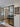 Modern interior with black-framed double glass doors, wooden floor, entry door, and decorative 'Be Kind to Your Mind' wall art