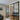 Modern black metal double doors with glass panels between living room and hallway