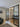 Modern black metal double doors with glass panels between living room and hallway
