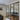 Modern black frame double glass doors with side panels separating living room and entryway