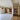 Modern interior with black framed glass double doors and side panels separating tiled and wooden floors