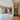 Modern interior with black framed glass double doors and side panels separating tiled and wooden floors