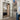 Modern double hinged black frame glass door in bright kitchen with built-in bookshelf and tiled floor