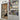 modern double hinged glass door with black frame next to white built-in bookshelf filled with books and assorted items