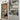 modern double hinged glass door with black frame next to white built-in bookshelf filled with books and assorted items