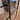Double hinged black metal frame glass door with modern handle in a stylish living room