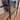 Double hinged black metal frame glass door with modern handle in a stylish living room