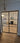 Modern black metal frame double hinged glass doors opening to stylish living room with fireplace and patterned chairs