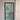 Modern hinged glass door with black frame and grid design, installed in white wall with blue carpet floor