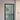 Modern black framed glass hinged door with white walls and blue carpet flooring