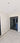 Modern double hinged glass door with black frame in bright room with marble floor