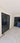 Modern interior with double hinged black steel frame glass doors and marble floor with decorative border