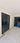 Modern interior with double hinged black steel frame glass doors and marble floor with decorative border
