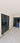 Interior hallway with double hinged black framed glass doors and marble floor with decorative border
