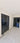 Interior hallway with double hinged black framed glass doors and marble floor with decorative border