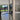 Modern double hinged black-framed glass door with marble floor and garden view