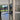 Modern double hinged black-framed glass door with marble floor and garden view