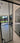 Modern double hinged black-framed glass door with marble floor and garden view