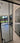Modern double hinged black-framed glass door with marble floor and garden view