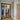Modern double hinged black metal frame glass interior door with herringbone wood floor