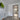 Modern interior with white walls, glass hinged door with black frame, wooden floor, and lime artwork