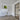 Modern interior with white hinged door, black-framed glass door, wood floor, and lime splash wall art