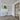 Modern interior with white hinged door, black-framed glass door, wood floor, and lime splash wall art