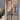 Double hinged door with black metal frame and glass panels in modern unfinished interior