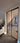 Double hinged door with black metal frame and glass panels in modern unfinished interior