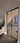Double hinged door with black metal frame and glass panels in modern unfinished interior