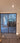 Double hinged glass door with wooden frame in modern unfinished interior
