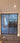 Double hinged glass door with dark metal frame and wooden handles in modern interior