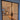 Modern black steel frame double hinged glass door in an unfinished room with wooden boards and stairs inside